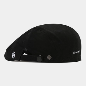 Black cotton newsboy cap with smiley face embroidery and adjustable side metal buckle