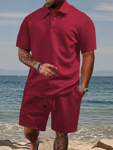 Detail of red men's polo set featuring textured diamond pattern fabric at the beach