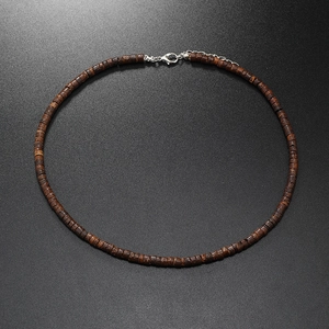 Macro view of coconut shell bead necklace with adjustable silver lobster clasp fastener