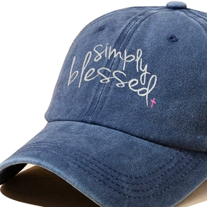 Simply Blessed washed navy cotton baseball cap with embroidered lettering and pink cross