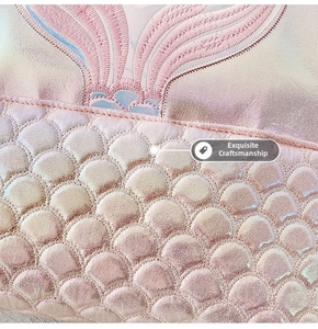 Detail of pink mermaid scale texture and fine embroidery on the large student backpack