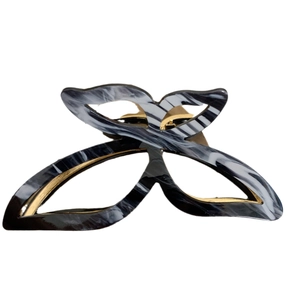 Elegant marble pattern butterfly hair claw clip with gold metal trim on white background