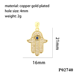 Macro detail of Hamsa Hand charm with gold plating and blue zirconia measurements
