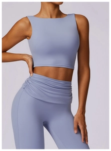 Detail view of high-waist yoga leggings with ruched crossover design in Morandi blue color
