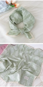 Detail of light green cotton linen square scarf with fern pattern and white lace trim