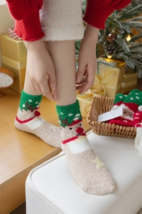 Close-up of fluffy Christmas reindeer socks with 3D antlers and festive holiday decor