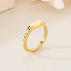 Close-up of polished gold heart ring featuring a high-gloss smooth mirror finish surface