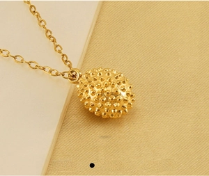 Detailed view of gold plated stainless steel durian pendant with fine texture
