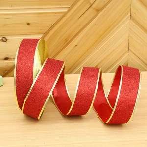 Close-up of red glitter ribbon with gold edges for Christmas tree decoration
