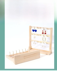 Detailed view of the wood jewelry display stand with three layers of metal hooks