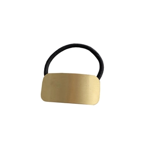 Minimalist black elastic hair tie featuring a polished gold rectangular metal ornament