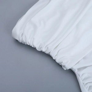 Detail of white dress showing elastic smocking texture and soft fabric craftsmanship