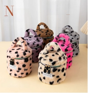 Group display of plush leopard print makeup bags in various colors with zip top handles