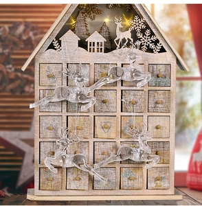 Detailed laser-cut wooden advent calendar house with LED lights and reindeer decor
