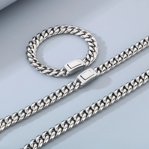 Close-up of a 12mm polished stainless steel Cuban link chain necklace and bracelet set