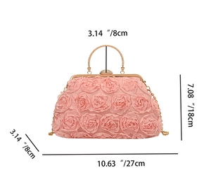 Detail of pink floral evening clutch with dimensions 27cm x 18cm x 8cm and gold handle