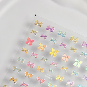 Detailed macro view of 3D aurora laser ribbon bow nail art stickers with metallic sheen