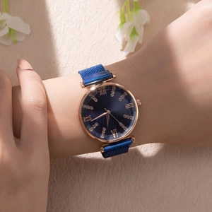 Elegant emerald green dial watch with rose gold case worn on wrist with crystals