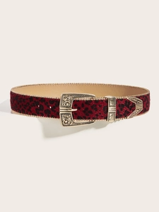 Detail of red leopard print belt with vintage gold engraved buckle and metal tip