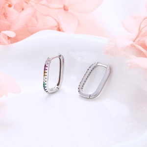 Macro detail of S925 sterling silver U-shaped hoop earrings with rainbow pavé cubic zirconia