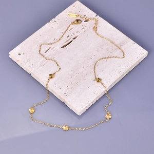 Detail of 18K gold-plated stainless steel necklace with delicate floral charms