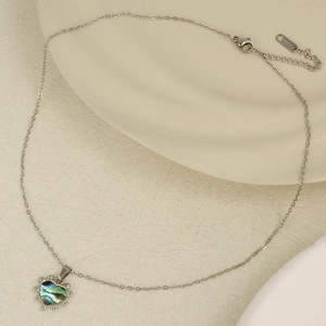 Detail of silver 304 stainless steel heart pendant with iridescent colorful shell inlay