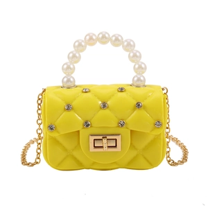 Quilted yellow jelly bag with pearl handle and gold chain strap in minimalist style