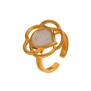 Detail view of the golden layered flower ring with a white spiral resin inlay