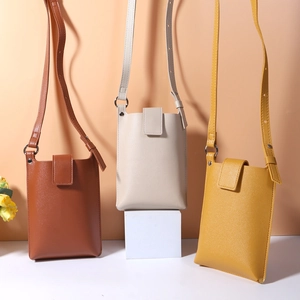 Detail view of mini PU leather phone crossbody bags in brown, beige, and yellow colors