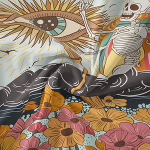 Close-up of Bohemian tapestry fabric showing eye and skull patterns with floral details