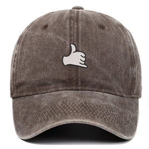 Detail of vintage washed brown cotton baseball cap with white Shaka sign embroidery