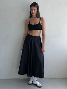 Detailed texture of black high waist satin maxi skirt and cropped camisole set