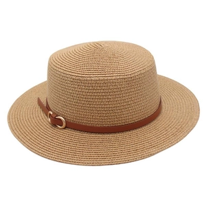 Close-up of woven straw texture and dark brown leather belt buckle on a boater hat