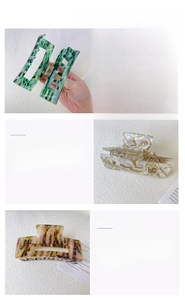 Detailed view of large acetate claw clips in marble, tortoiseshell and green patterns