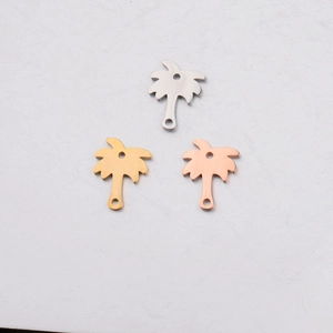 Detail of mirror-polished coconut tree pendants in silver, gold, and rose gold finishes