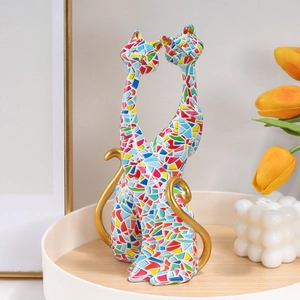 Colorful resin cat sculptures with golden accents on a wooden tray for home decor