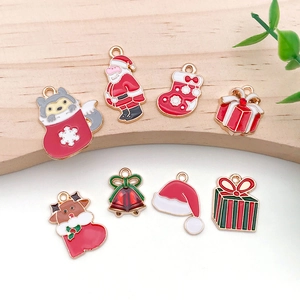 Detail of Christmas enamel charms including Santa, elk, and bells for DIY jewelry making
