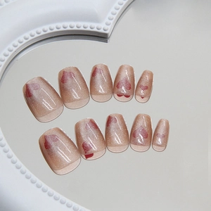 Pink cat eye press-on nails with silver glitter and red heart patterns in a 10-piece set