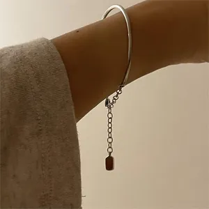 Detailed close-up of a minimalist S925 silver cuff bracelet with an adjustable tail chain