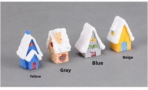 Detail of four miniature winter cottage figurines with snow roofs for DIY micro landscapes