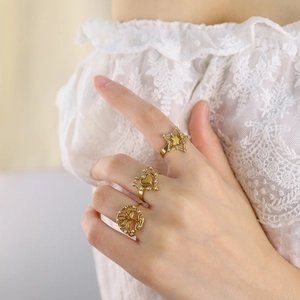 Set of three gold plated rings featuring star, heart, and tree of life with zircons
