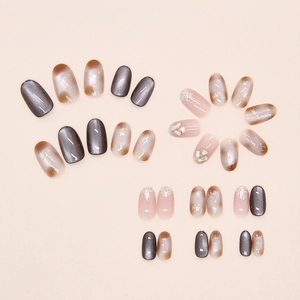 Detailed view of brown cat eye press-on nails with champagne glitter and rhinestones