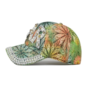 Detail of tropical print baseball cap with embedded rhinestones and pearl PIR lettering