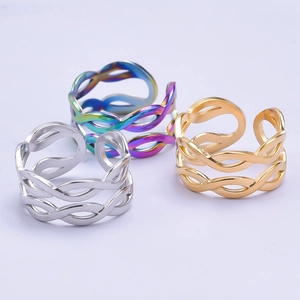 Detailed view of woven hollow adjustable rings in silver, gold and rainbow finishes