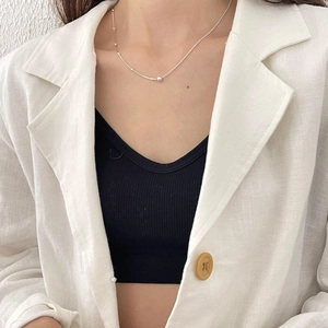 Minimalist 925 sterling silver beaded snake chain necklace worn by a fashion model