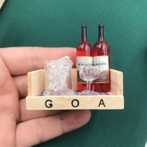Detailed macro view of miniature wine bottles and ice bucket in a small wooden crate