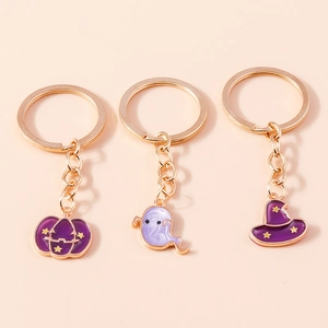 Detailed set of three purple enamel Halloween keychains with gold metal trim and charms