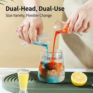 Double-headed graduated measuring cup for cocktails with clear scale and lemon slices