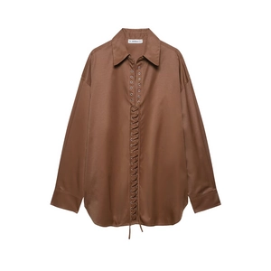 Detail of dark brown satin shirt featuring unique eyelet lace-up front and classic pointed collar