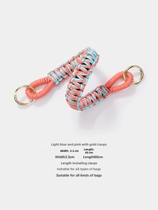Detail of pink and light blue woven bag strap with 3.3cm width and gold round clasps